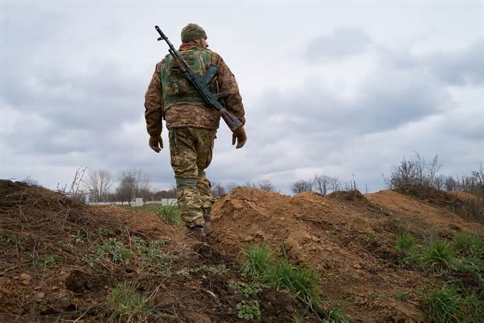 A Ukrainian soldier stands guard