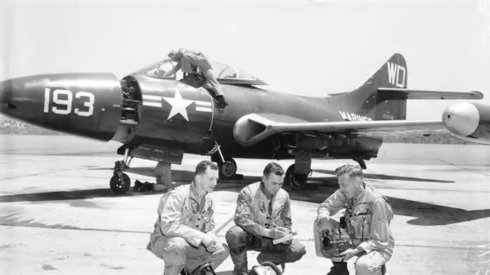 three pilots in front of F9F Panther jet