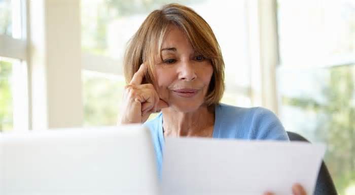 A 60-year-old woman reviews her IRA balance as she plans for retirement.