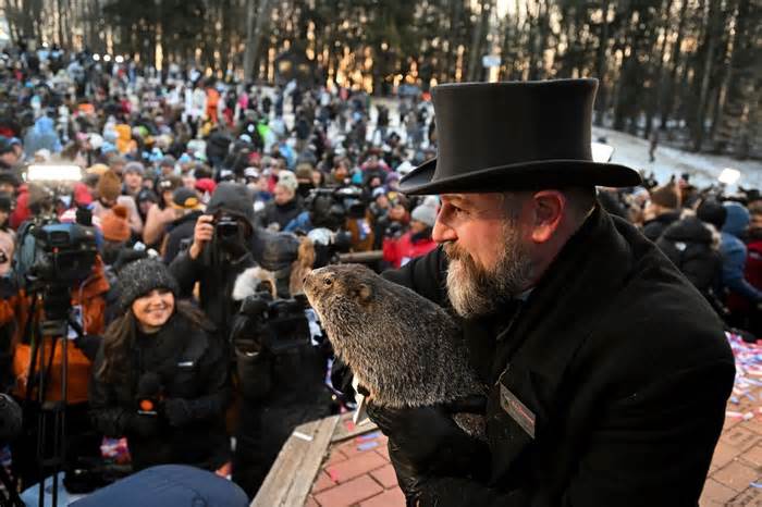 A handler holds Punxsutawney Phil, the weather prognosticating groundhog, during the 137th celebration of Groundhog Day in Punxsutawney, Pa., in 2023.
