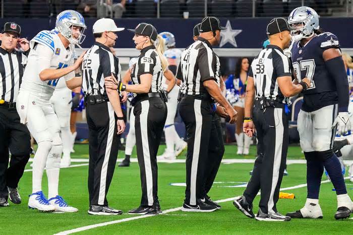 Detroit Lions quarterback Jared Goff (16) and Dallas Cowboys defensive tackle Osa Odighizuwa (97) talk to officials after a penalty negated a potential game-winning Lions two-point conversion in the final seconds of the second half of the Cowboys 20-19 victory in an NFL football game at AT&T Stadium on Saturday, Dec. 30, 2023, in Arlington.