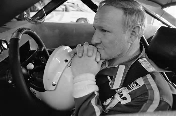 Race car driver Cale Yarborough maintains a pensive pose in the driver's seat of his car in the garage area at the Daytona Speedway, Daytona Beach, Fla., Feb. 10, 1979. Yarborough will run in the Busch Clash 50-mile sprint race against the top drivers in the business, but said the engine in one of his cars was giving him trouble. (AP Photo/Kathy Willens)
