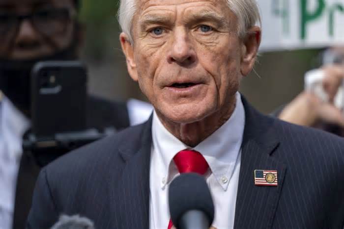 Peter Navarro, an adviser to former president Donald Trump, speaks to the press as he is surrounded by demonstrators after being found guilty of contempt of Congress in September 2023. A federal judge of Tuesday threatened Navarro again with contempt charges if he does not turn over emails that are designated 