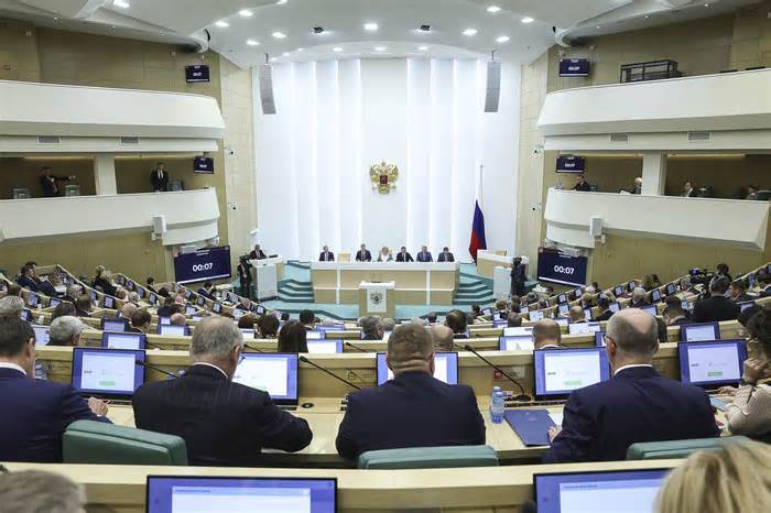 In this photo provided by The Federation Council of The Federal Assembly of The Russian Federation Press Service, lawmakers of Federation Council of the Federal Assembly of the Russian Federation attend a session in Moscow, Russia, Wednesday, Oct. 25, 2023. The upper house of the Russian parliament has revoked the ratification of a global nuclear test ban in what Moscow has described as a move to put itself on par with the United States. (Federation Council of the Federal Assembly of the Russian Federation via AP)