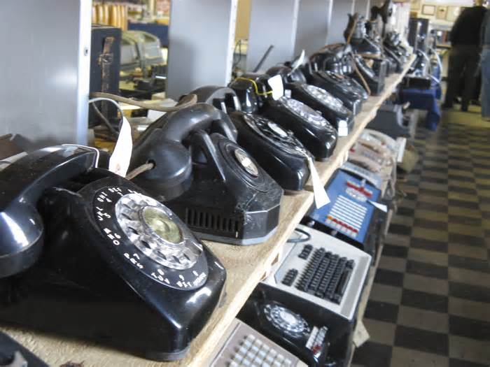 In a Saturday Nov. 12, 2011 photo, rows of old and newer telephones along with office switchboards are in the museum operated by members of the Parkersburg Council of the Telecomm Pioneers in Parkersburg, W.Va. As Thursday, Feb. 22, 2024, cell phone outage shows, sometimes landline telephones can come in handy, and were suggested as part of the alternatives when people's cell phones weren't working. (]Jeffery Saulton/News and Sentinel via AP)