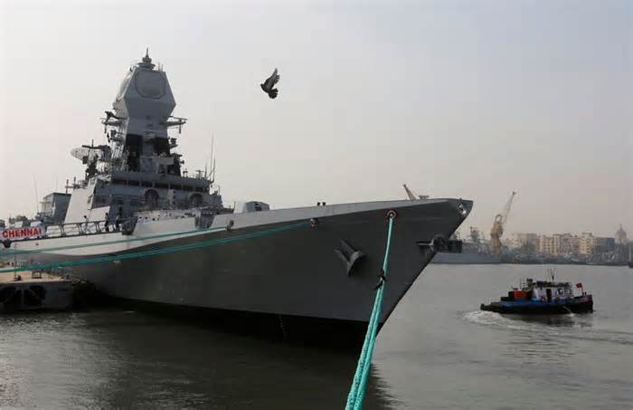 A bird flies past the newly built INS Chennai, India’s third indigenously designed guided missile destroyer, ahead of its commissioning into the Navy in Mumbai