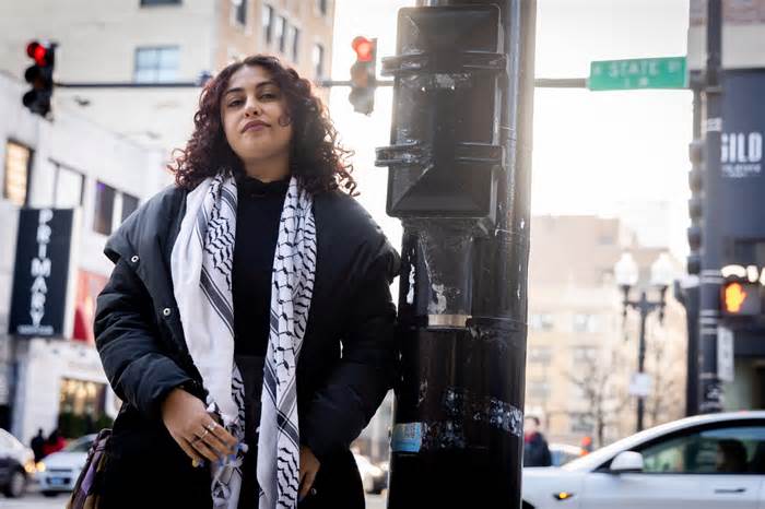 Celine Khalife, 25, at the street post in Chicago where she was videotaped tearing down a poster of Israeli hostages.