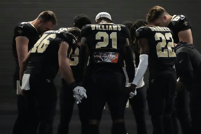 New Orleans Saints players huddle in a tunnel before an NFL football game against the Atlanta Falcons in New Orleans, Sunday, Jan. 7, 2024. (AP Photo/Gerald Herbert)