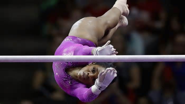 Douglas competes on the uneven bars during the 2016 US Olympic team trials. - Ronald Martinez/Getty Images