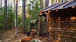 Survival in a log hut during a severe wind. Handmade wooden furnishings.