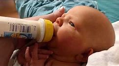 Baby Using His First Bottle
