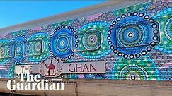 Australia's transcontinental Ghan train transformed into stunning moving Aboriginal artwork – video