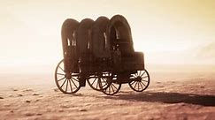 Canvas Covered Retro Wagon in Desert at Sunset