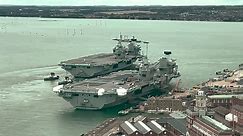 Aircraft carrier HMS Prince of Wales is towed to Portsmouth Naval base