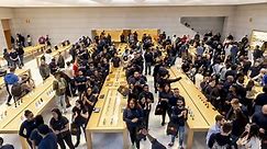 Apple CEO Tim Cook throws open the doors to the redesigned Apple store on Fifth Avenue in New York City.