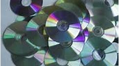 A man discards many CDs and DVDs that are not useful anymore due to...