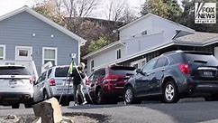 Investigators outside the home where four University of Idaho students were slain in November last year