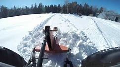 Farm tractor plowing snow