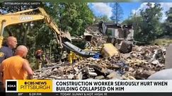 Worker rescued from excavator after building partially collapses during demolition