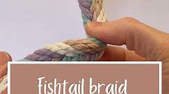 How to create a fishtail braid using macrame cord: 1. Separate the hanging cords into two even sections. In this case, I started with 8 hanging cords and separated them so there were 4 cords on each side. 2. Hold the sets of cords apart, then take the cord on the left and bring it over the left set of cords into the middle. 3. Then take the cord on the right and bring it over the right set of cords into the middle. 4. Repeat steps 2-3 until you reach the desired length. This braid can be used to