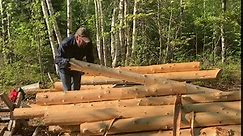 Building an off grid log cabin and building a outhouse alone in the wilderness.