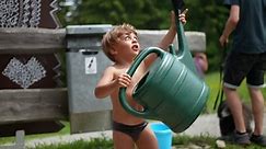 Little Boy Holding Watering Can Outside Stock Footage Video (100% Royalty-free) 1089057325 | Shutterstock