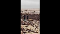 California beach littered with debris as storms caused widespread flooding, damage