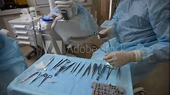 Dentist and assistant with Dental drill, syringe, dental mirror and other dental equipment before surgery wisdom tooth extraction in professional dental clinic. 4k raw cinematic slow motion video