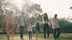 Happy Asian family walking in the park, Outdoor with big family and summer season concept
