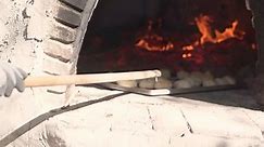 Cooking bread in clay oven traditional bakery of pastry in slow motion