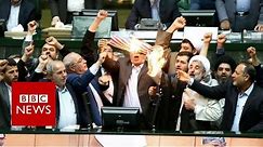 Iranian politicians set fire to US flag in parliament - BBC News