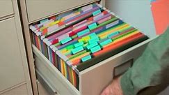 1920x1080 Businessman opens filing cabinet drawer, files folders.