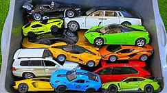 Box full of various miniature cars Peugeot, Volvo, Renault, Hyundai, Pagani, Cadillac One, DHL 79