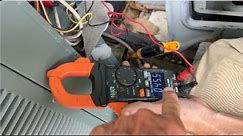 HVAC Tech Checking the electrical on Condenser Rheem AC