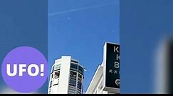 This spooky footage has gone viral after appearing to showing two UFOs hovering over a city.
