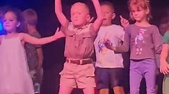Confident kid has a blast dancing on a stage
