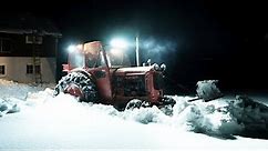 Vintage Tractor Plowing Heavy Snow