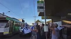 Moment motorist nearly drives ute into a group waving Israel flag