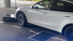 Tesla driver runs over charging station and drags it away