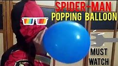 spiderman is popping the balloons
