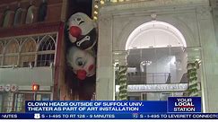 Clownin’ around: Clown heads hanging outside of Suffolk Univ. theater as part of art installation