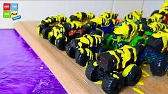 Line of colorful monster trucks fall into water for kids