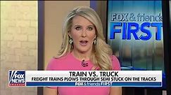 Freight train plows through tractor trailer stuck on tracks