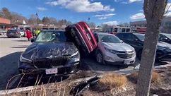 Audi wedged on side after parking lot crash