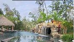 How long is this INSANE POOL? This backyard features a giant walk-through grotto, koi pond, waterfalls, outdoor kitchen, tiki hut, raised spa, a sun shelf, swim-up bar, and a tree house! Visit lucaslagoons.com to see more of this project. #insanepools #lucaslagoons #pool #poolbuilders #backyard #luxurylife #tikihut | Lucas Lagoons