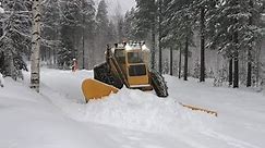 Volvo Tractor Snow Plowing village in Lappland.