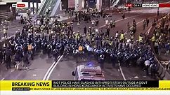 Riot police rush at Hong Kong protesters