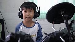 Kid sing song and beat drumstick in hard rock music at home. Asian child boy play electronic drum with headphone. Concept of music learning, happy relaxing time, freedom, little kid musician.