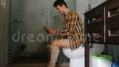 Man Sitting on Toilet Use Cell Smart Phone Young Guy Chatting Online Stock Footage - Video of phone, message: 102199358