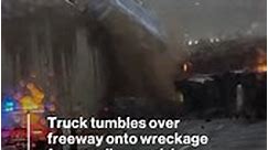 Truck tumbles onto crash wreckage